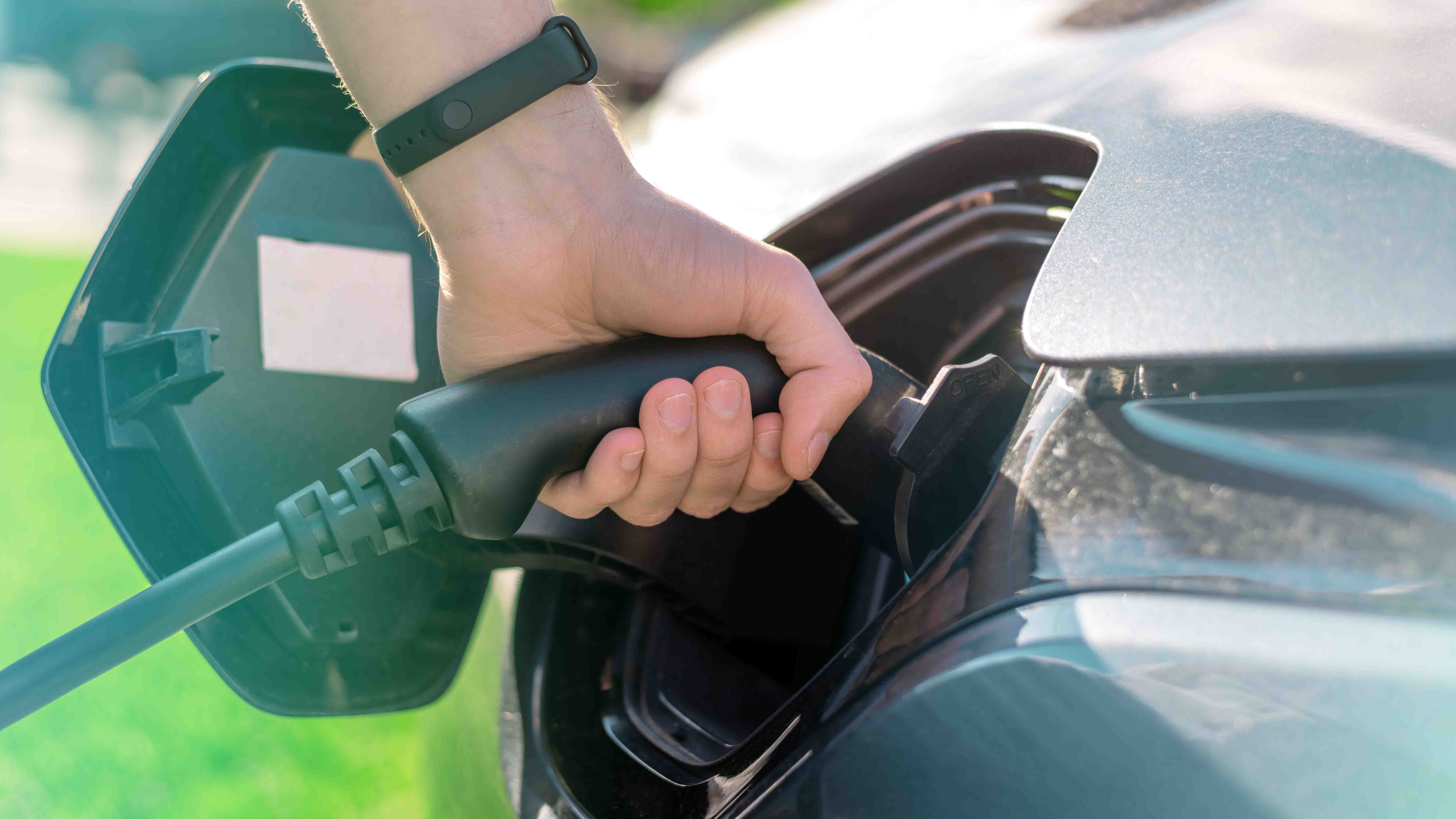 plugging-charger-into-electric-car-charge-station