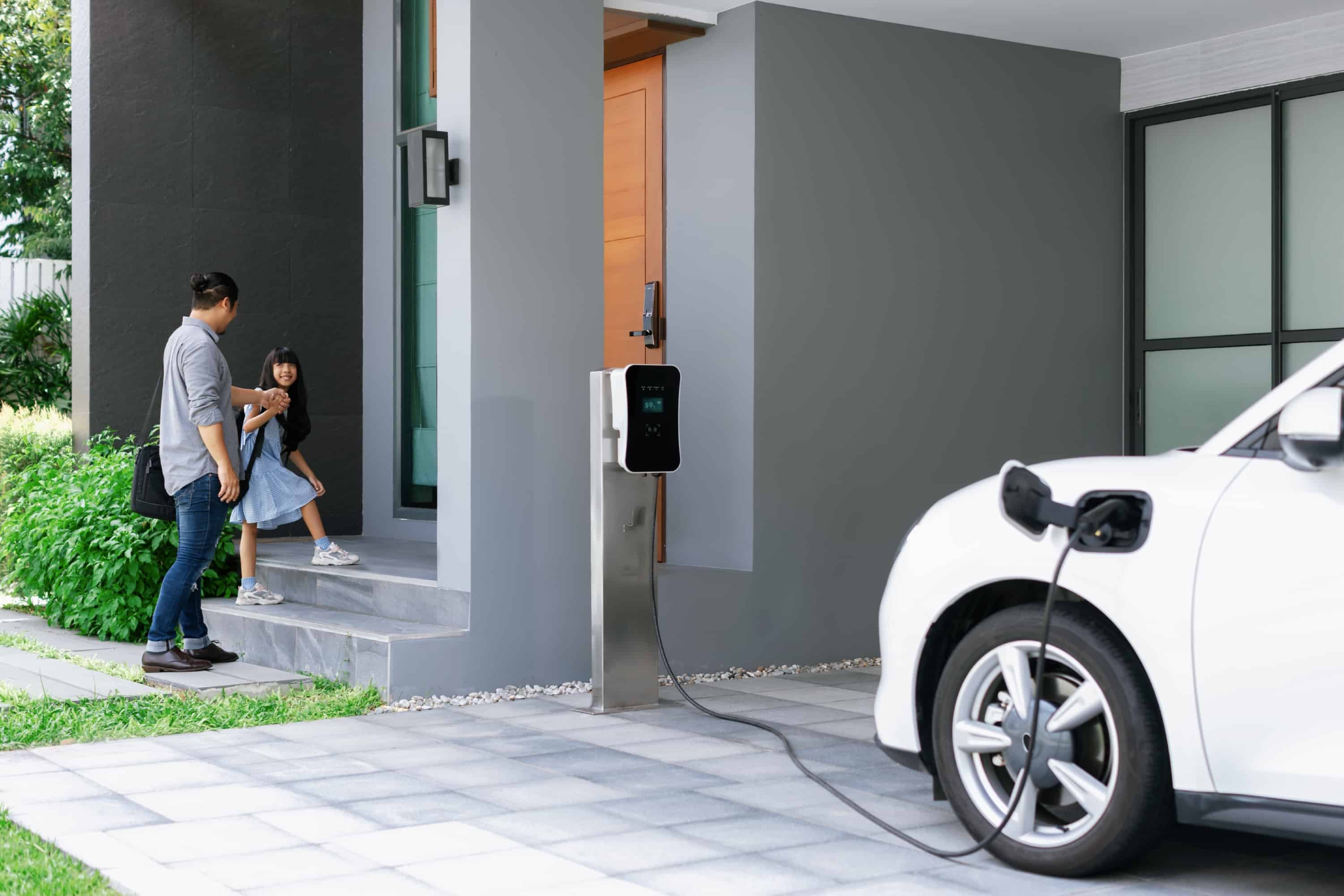 progressive-dad-daughter-charging-ev-car-from-home-charging-station
